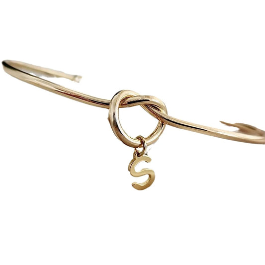 "Gold Initial Charm Bangle Bracelet" can be rewritten as "Personalized Gold Initial Charm Bangle".